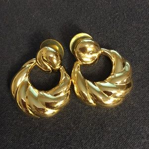 Gold tone door knocker earrings. Pierced
